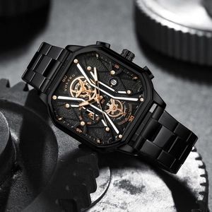 Macro detail of men's watch featuring black square dial with gold hands and exposed gears