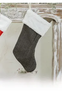 Close-up of cable knit Christmas stocking with white faux fur cuff on a mantel