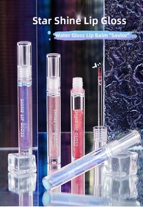 Detail of glitter lip gloss tubes in purple and rose shades with crystal ice blocks