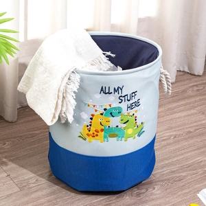 Detail of blue dinosaur toy storage basket with cotton rope handles on wood floor