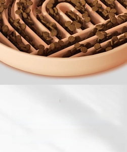 Detail of slow feeder pet bowl with spiral maze design and dry food for dogs