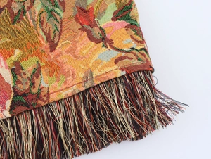 Close-up of vintage oil painting style tapestry dress with colorful floral fringe details