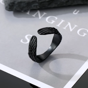 Detailed top view of black gothic wing ring showing intricate metal texture on dark stone