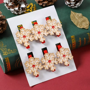 Detailed close-up of 6-piece wooden snowflake clips for Christmas party and holiday decoration
