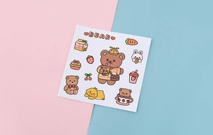 Detailed view of cute brown bear stickers with milk tea and strawberry icons for scrapbooking
