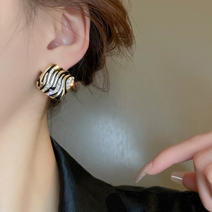Vintage geometric square earrings with black striped enamel and crystal inlay on model