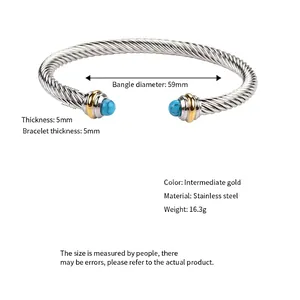 Adjustable stainless steel cable twist bangle with turquoise accents and gold-plated rings
