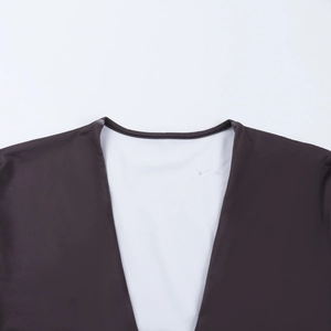 Detail of deep V-neckline showing double-layer fabric and white lining contrast
