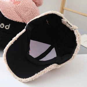 Detail of baby bear baseball cap showing black inner lining and premium stitching