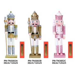 Three 30cm glittery wooden nutcracker king figures in silver, gold, and pink with red gift boxes