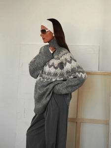 Detailed view of the retro geometric knit pattern and high neck on the grey oversized sweater