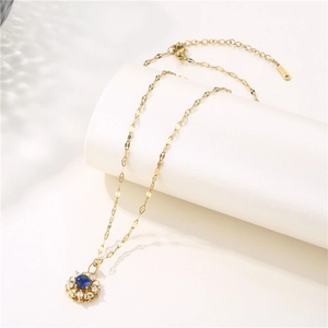 18K gold plated S925 silver necklace with blue gemstone flower pendant on white background