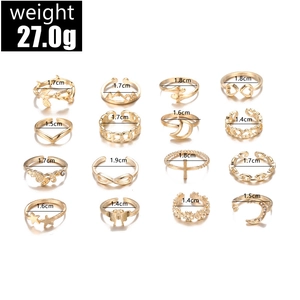 Macro view of 16-piece gold alloy ring set with diverse diameters on white background