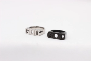 Close-up of hip hop GOD cutout design on silver and black stainless steel rings