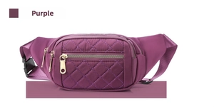 Detail view of purple quilted fanny pack with multiple zipper pockets and adjustable belt