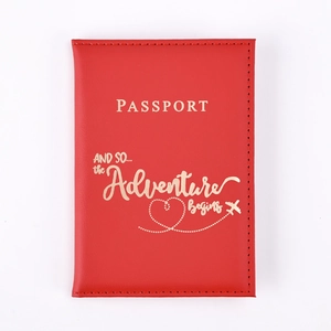 Detail of red PU leather passport cover with gold embossed adventure quote and icons