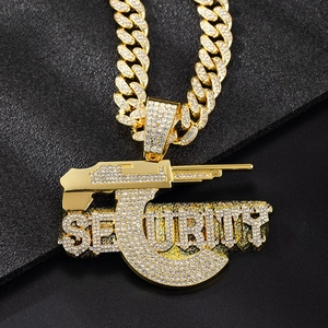 Macro detail of gold-plated security pendant with sparkling rhinestones on cuban chain