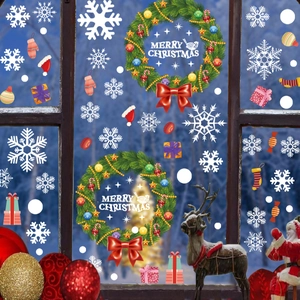 Christmas wreath and snowflake static window decals on glass with festive holiday decorations