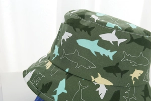 Close-up of cotton canvas texture with colorful shark prints on a green bucket hat