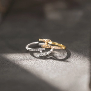 Crossed T-shaped open rings with pavé cubic zirconia in gold and silver finish