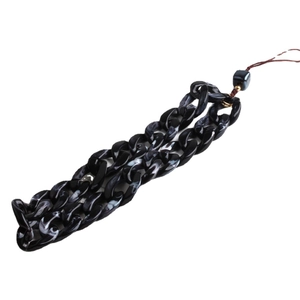 Bohemian acrylic phone strap featuring black and white marble links and gold bead accents