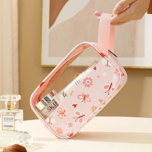 Pink macaron print makeup bag with transparent sides and convenient handle for travel storage