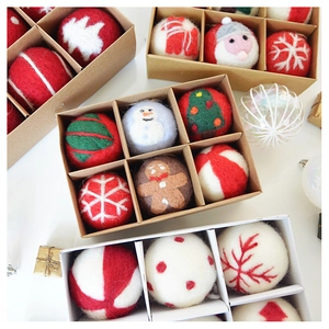 Macro shot of assorted Christmas felt balls featuring Santa and gingerbread man designs