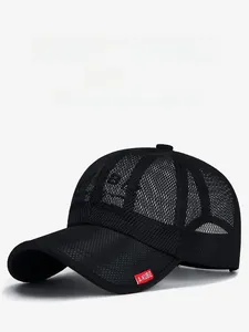 Detail showing the breathable black mesh fabric and red label on the baseball cap