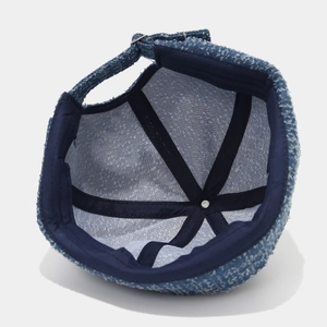 Detail view of the vintage denim brimless docker hat showing interior lining and adjustable strap