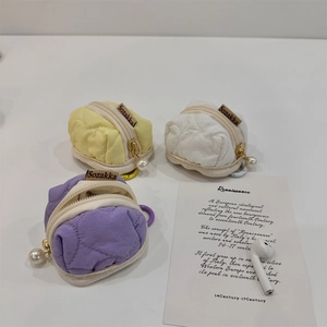 Detail of heart quilted texture on small fabric pouches with pearl zipper sliders