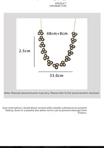 Detailed size chart showing a 48cm gold chain necklace with black swirl enamel pendants