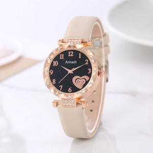 Detail of rose gold watch case with crystal accents and starry heart pattern dial