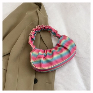 Detail of colorful rainbow pleated shoulder bag with unique gradient stripes and texture