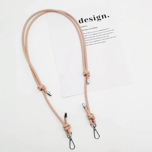 Adjustable beige PU leather bag strap with silver metal swivel hooks and knot detail