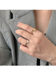 Close-up of minimalist wave pattern S925 sterling silver rings in gold and silver finish