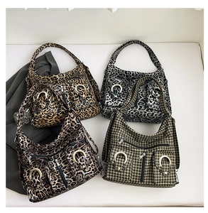 Detail view of multi-pattern hobo bags featuring leopard print and houndstooth texture
