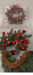 Close-up of Christmas swag with red berries, pine needles and a buffalo plaid bow