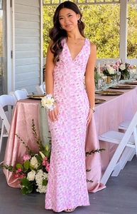 Close-up of pink floral lace fabric on a slim fit V-neck backless evening gown