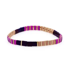 Detailed close-up of handmade Bohemian stretch tile bead bracelet in purple and gold tones