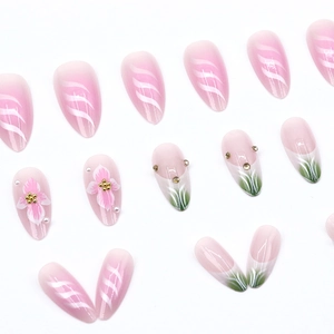 French style almond press-on nails with metallic stripes and floral patterns in pink white