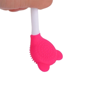 Pink silicone cat paw facial cleansing brush with soft bristles and ergonomic white handle