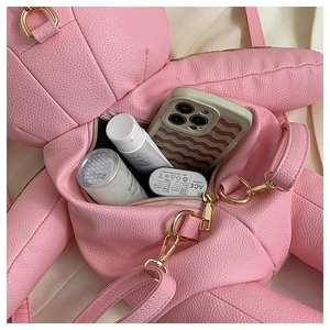Pink teddy bear backpack with gold hardware showing interior capacity and PU leather texture
