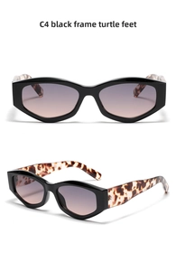 Detail view of black cat-eye frames with classic tortoiseshell temples and gradient lenses
