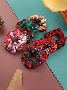 Close-up of festive Christmas plaid scrunchies with pine cones and winter holiday decor