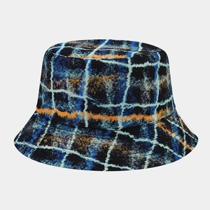 Detail of graffiti pattern bucket hat with vibrant orange stripe on a white background