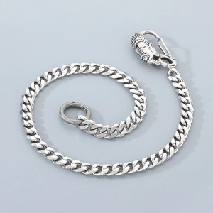 Detail shot of silver titanium steel street style jeans chain with buddha head carabiner