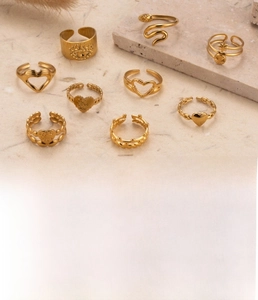 Detailed set of nine gold titanium steel rings featuring heart and snake motifs