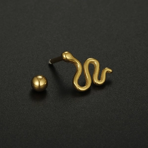 Macro shot of 16G gold-plated snake-shaped cartilage stud earring with screw-back detail