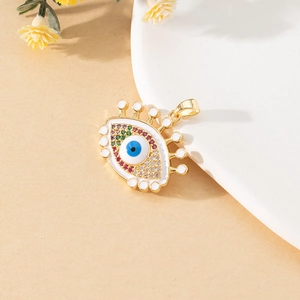 Detailed view of evil eye pendant with enamel and colorful zircons on ceramic tray