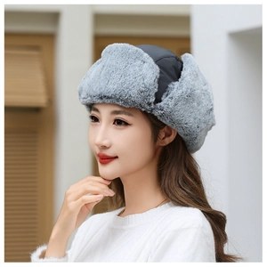 Detail of gray faux fur lining and windproof fabric on thermal winter trapper hat